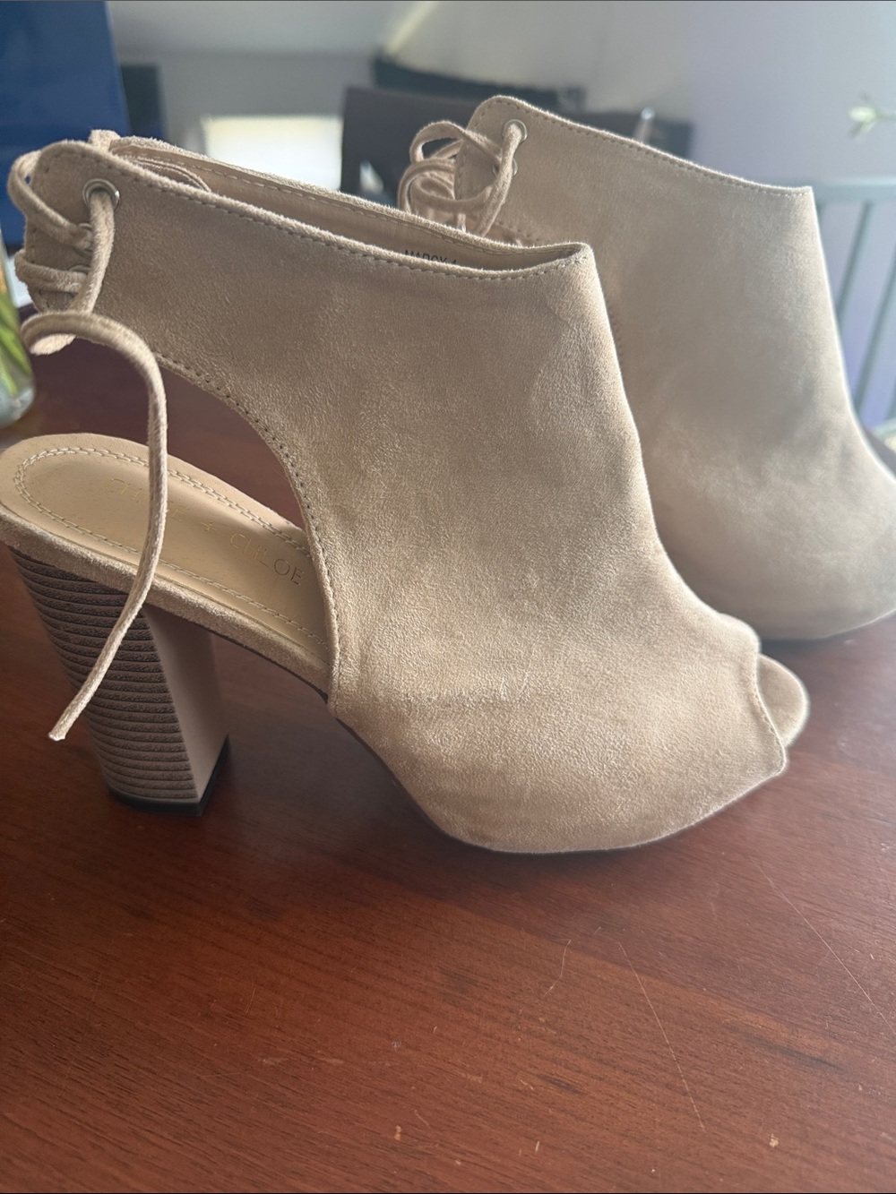 Chase & Chloe lace-up back booties in a nude or beige color.